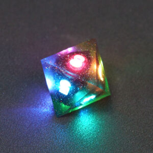 Lit Midnight Galaxy D8 with a rainbow of colors across each face. Midnight Galaxy colorway is a mostly translucent dark smoke black resin base packed with rainbow glitter of various sizes. The numbers or symbols are painted pearl white.